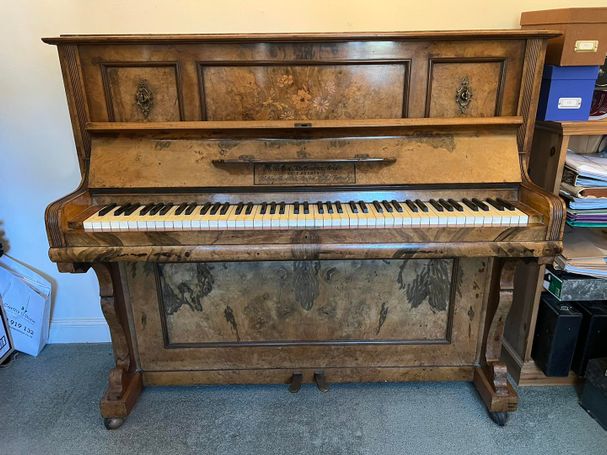 Gors and Kallmann period walnut cased German upright piano.